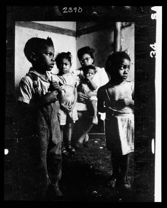African American mother and her four children in their tenement apartment