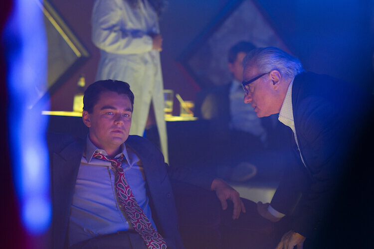 Director/Producer Martin Scorsese (right) discusses a scene with Producer Leonardo DiCaprio (as Jordan Belfort, left) on the set of THE WOLF OF WALL STREET, from Paramount Pictures and Red Granite Pictures. TWOWS-00443