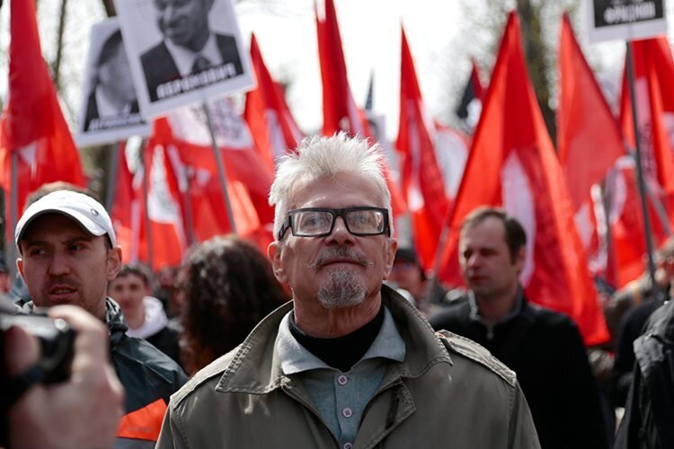 Opposition leader Eduard Limonov leads his supporters as they take to the streets to mark May Day in Moscow, Russia, on Wednesday, May 1, 2013. Thousands of Communists, members of Russia's main political parties and opposition activists staged competing marches in Moscow and other cities Wednesday marking the traditional May Day holiday. Ivan Sekretarev/AP